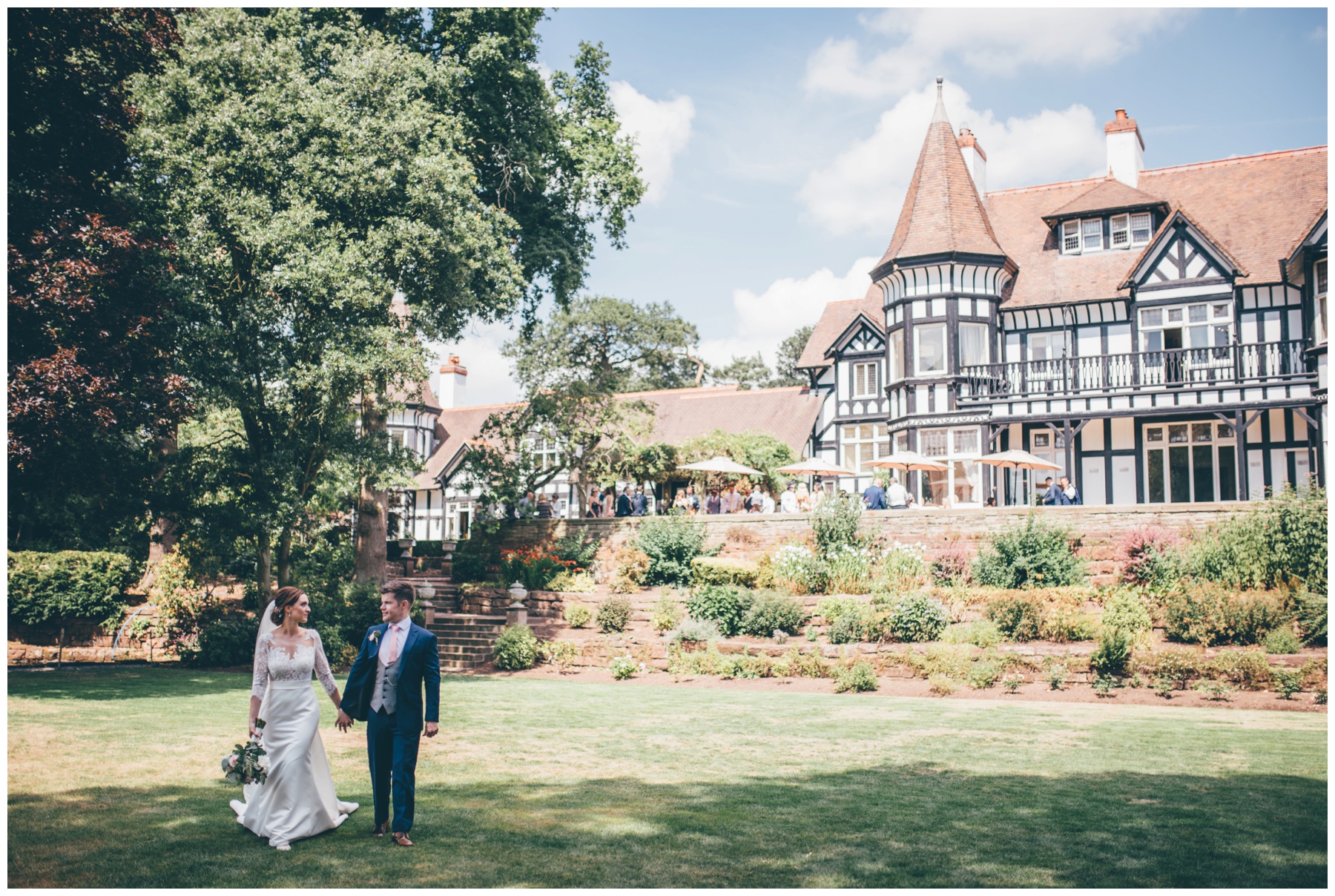 Newlyweds stroll across the beautiful grounds at Tilstone House in Tarporley.