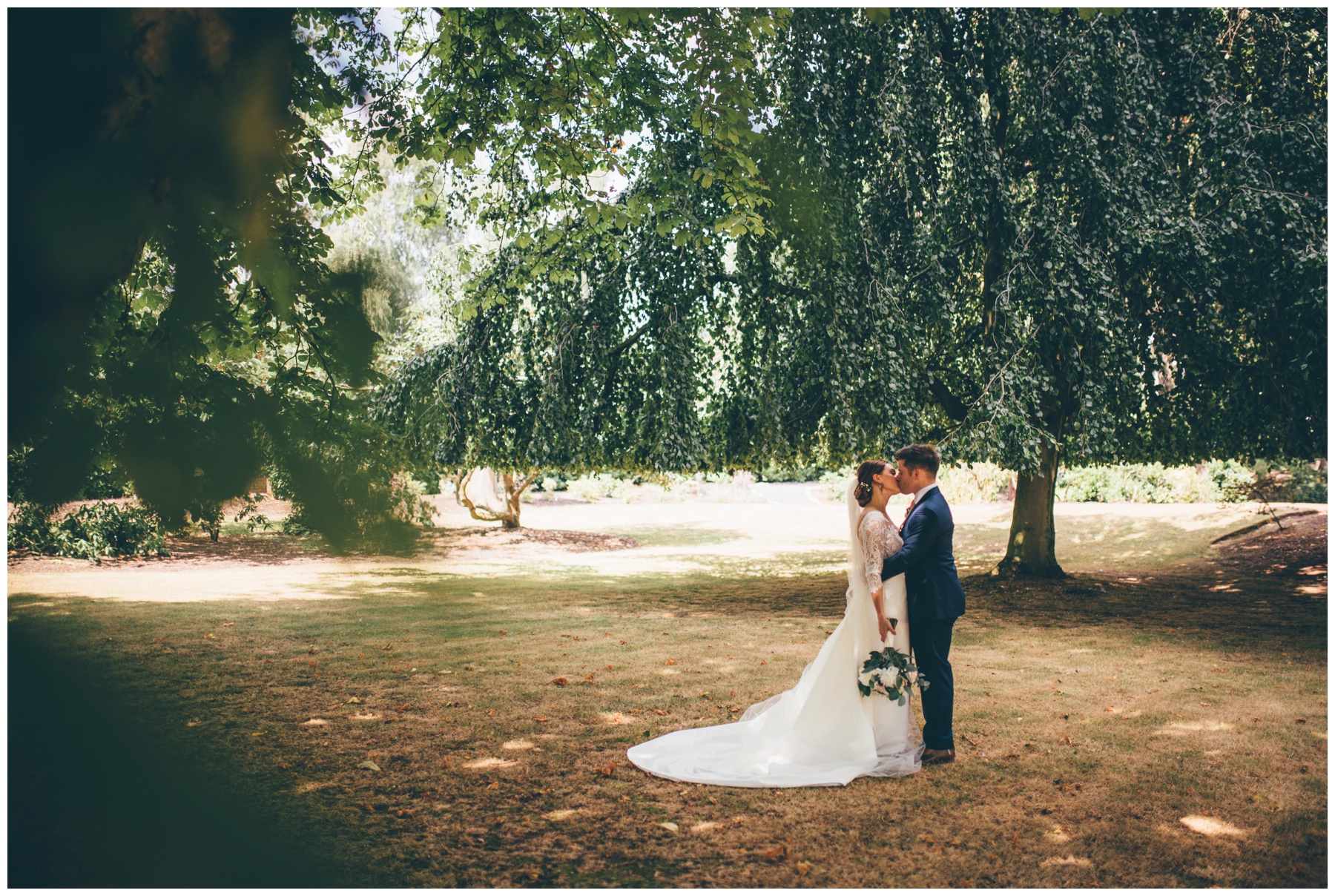 Beautiful bride and groom in the grounds at Tilstone House in Cheshire.