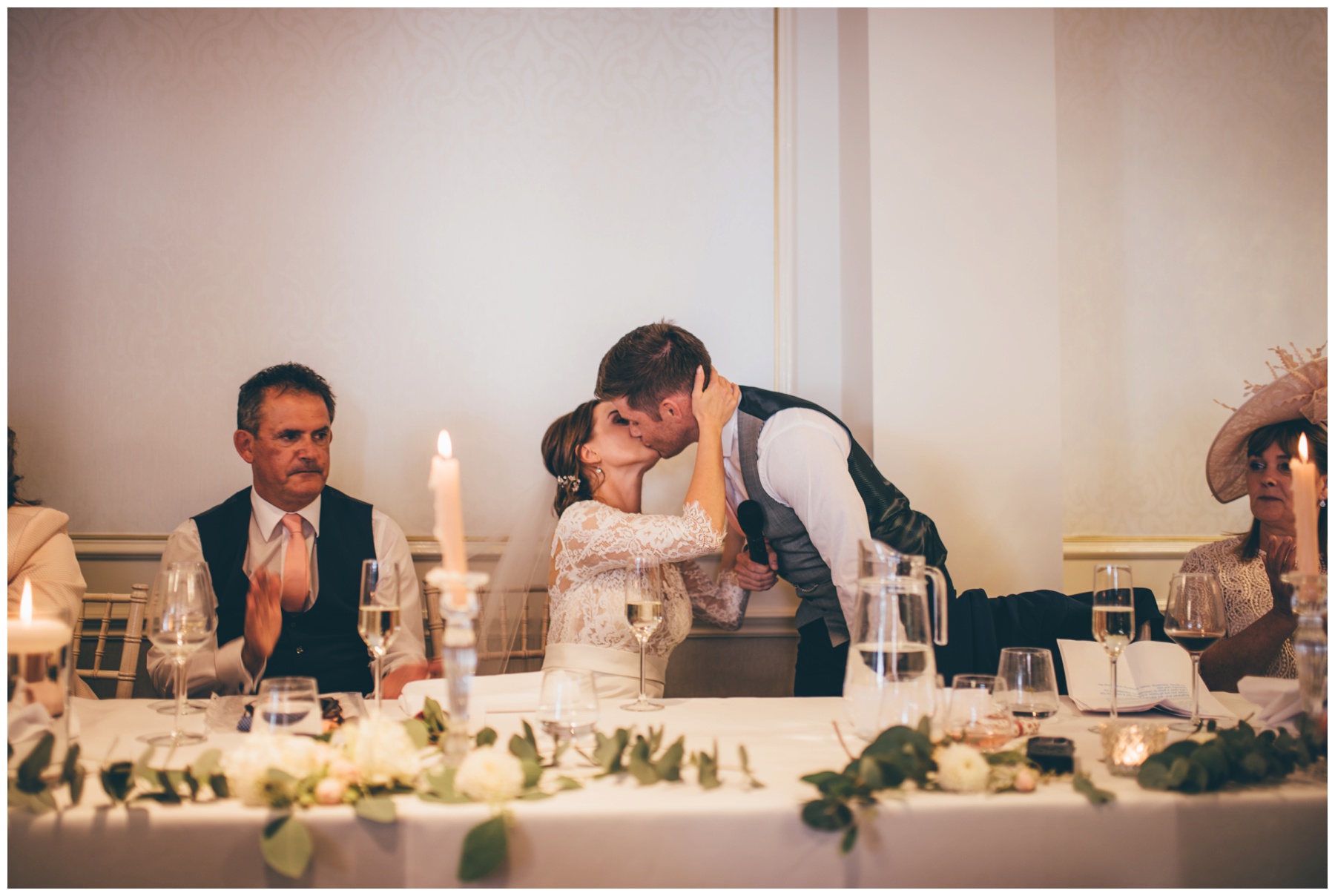 Bride and groom kiss after the speeches at Tilstone House.