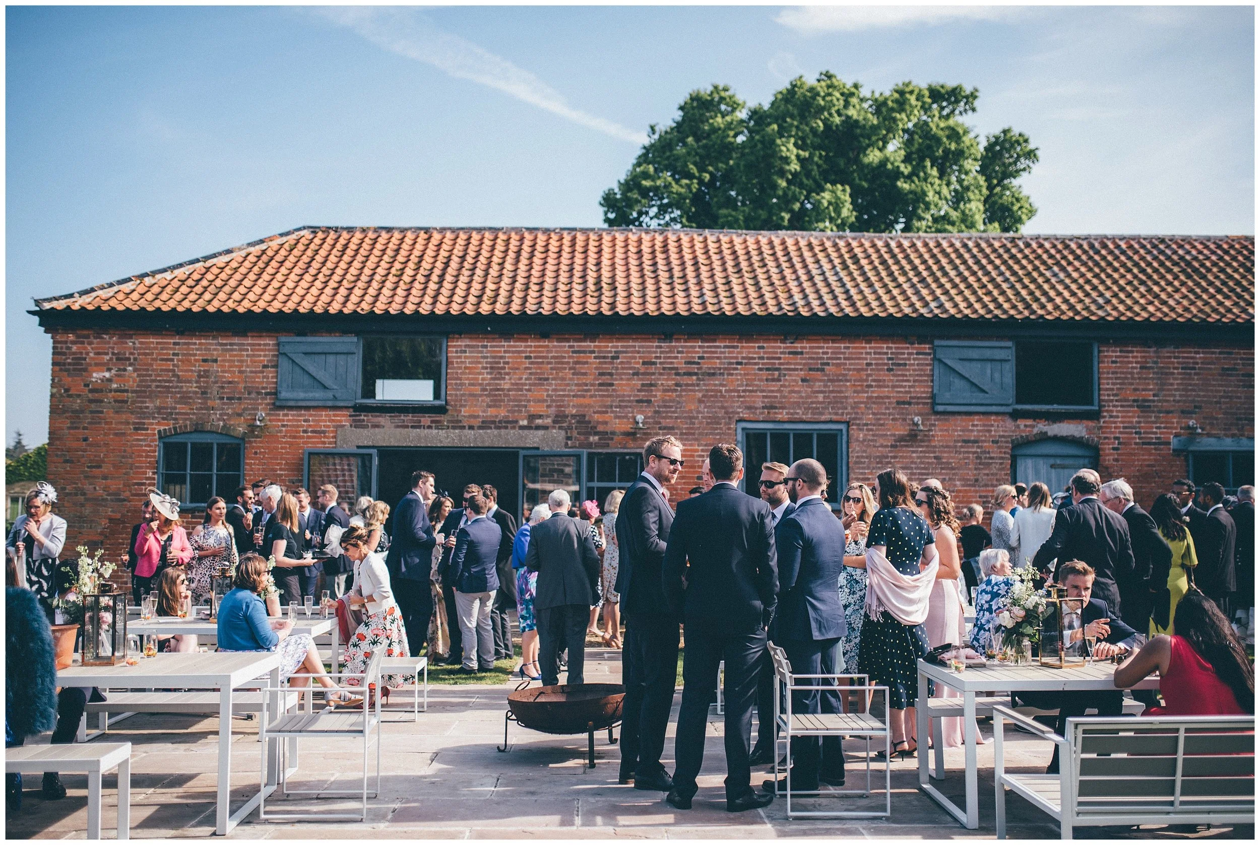 Wedding guests enjoying the reception at Henham wedding barns.