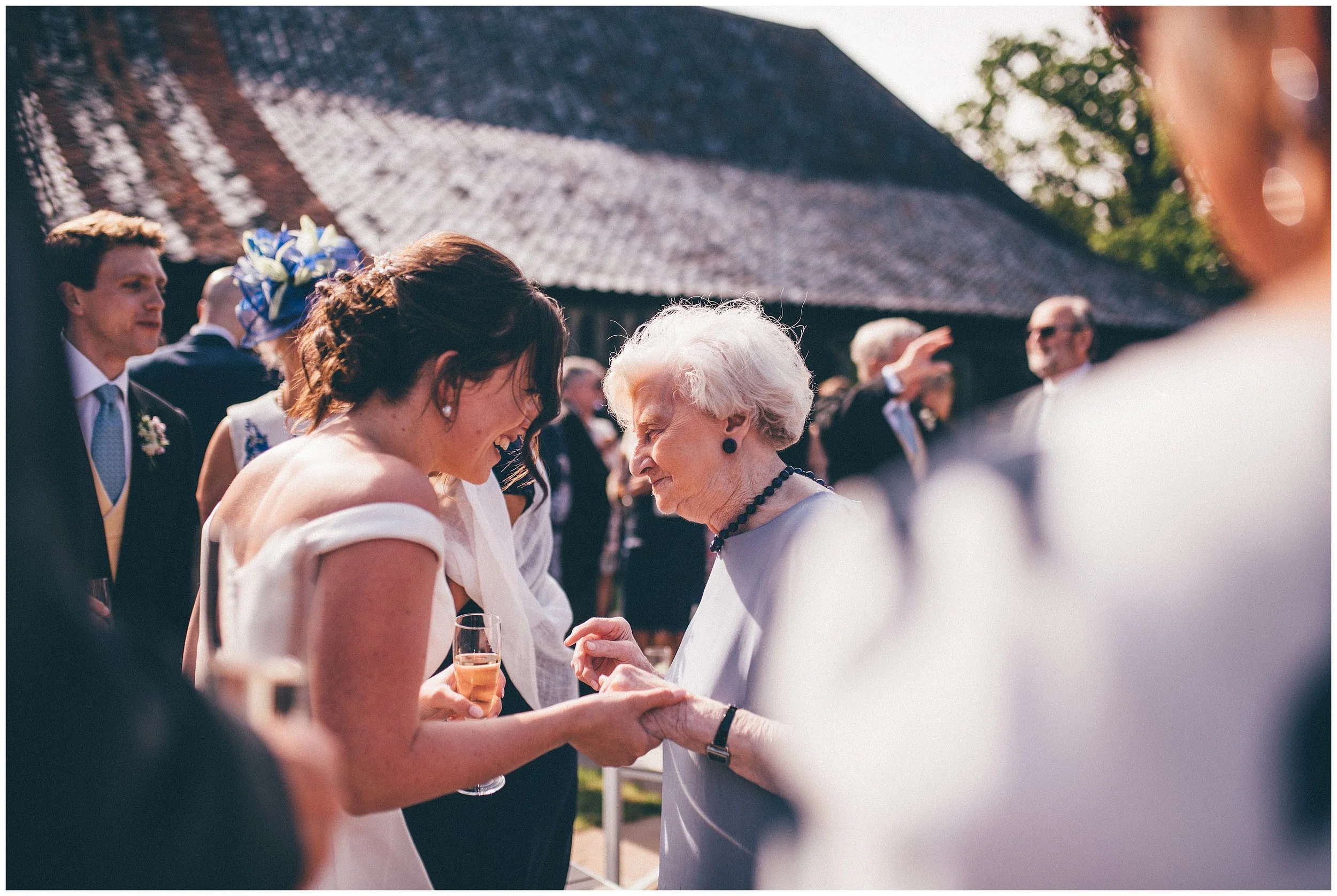 Wedding guests enjoying the reception at Henham Park wedding barns.