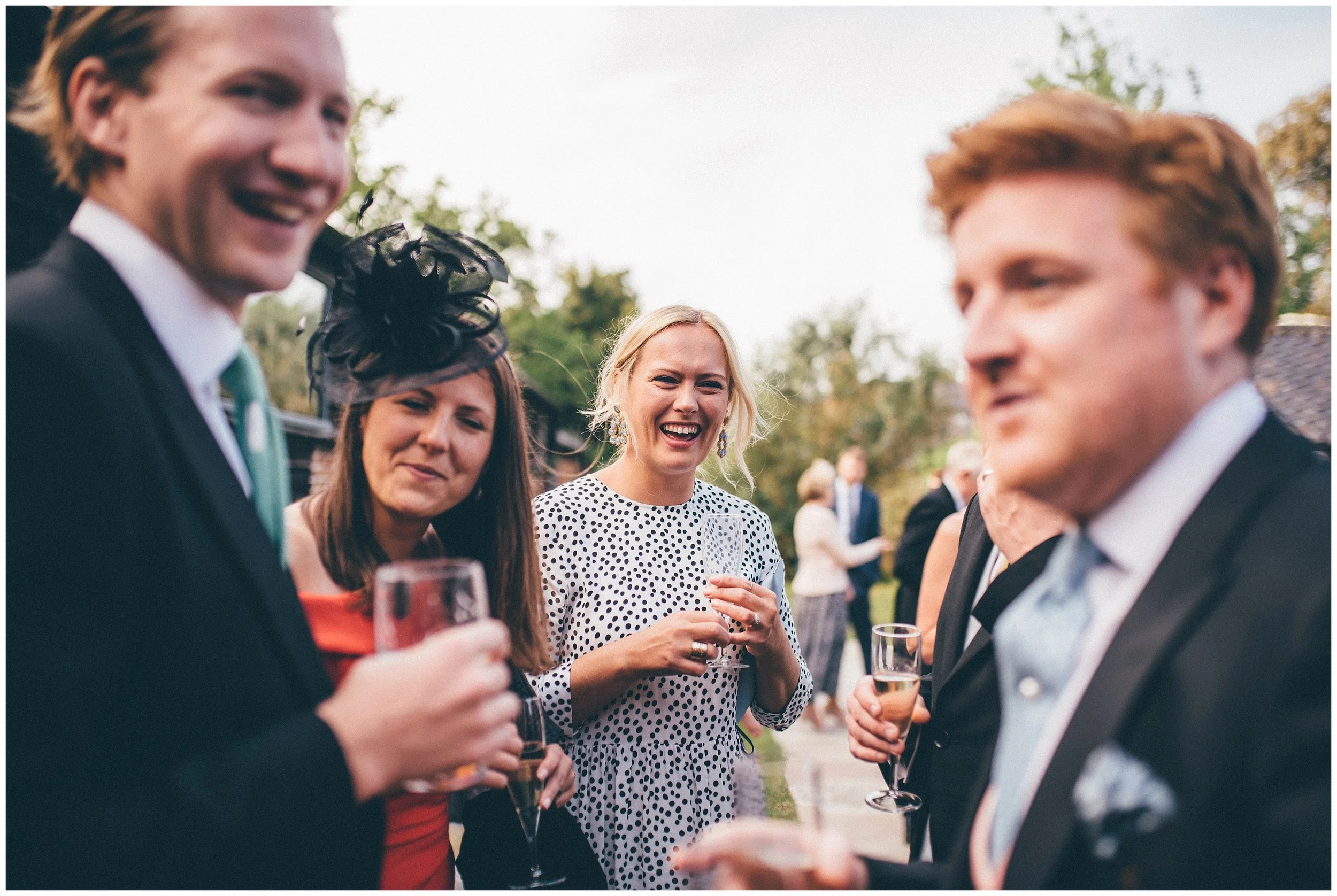 Wedding guests enjoying the reception at Henham Park wedding barns.