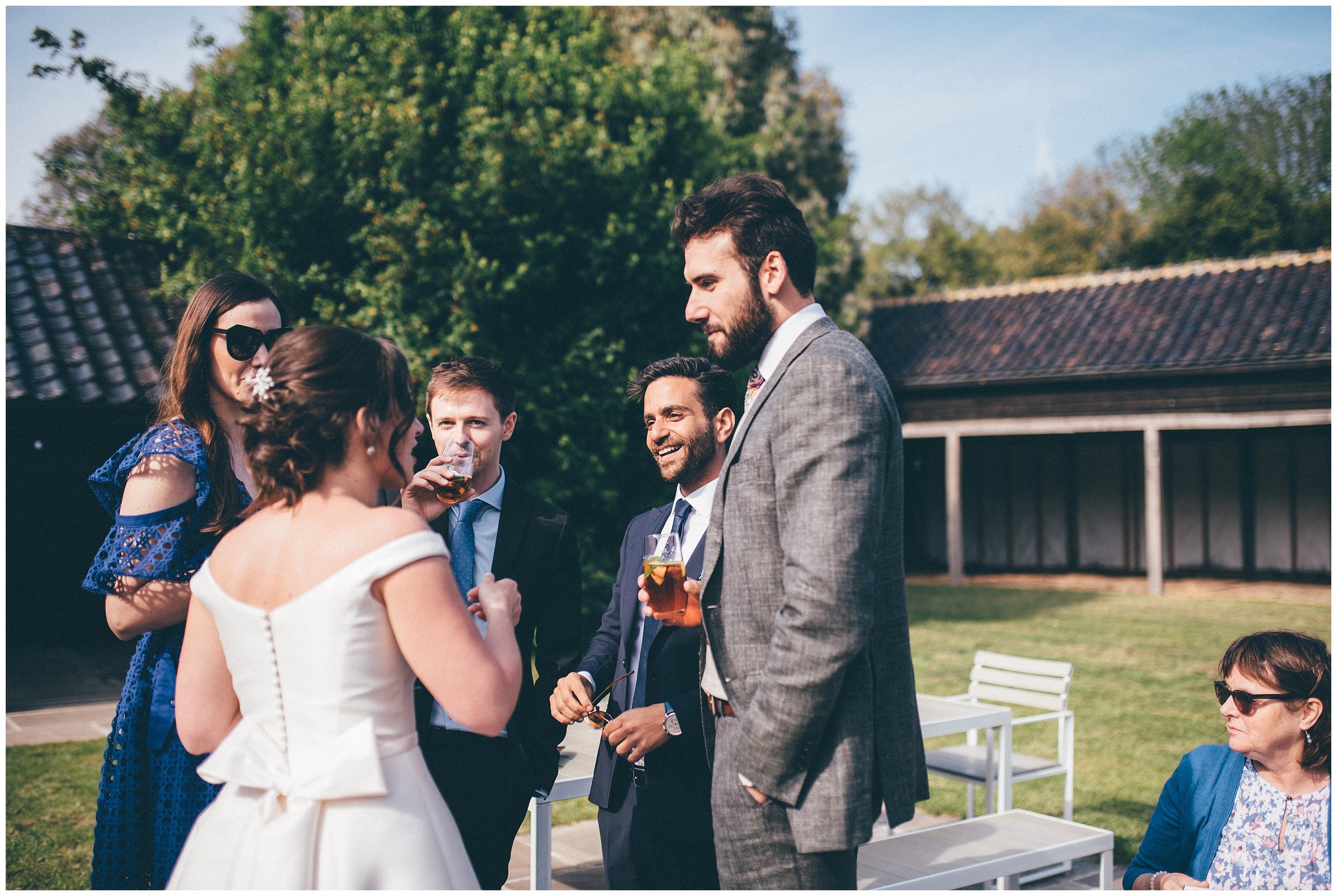 Wedding guests enjoying the reception at Henham Park wedding barns.