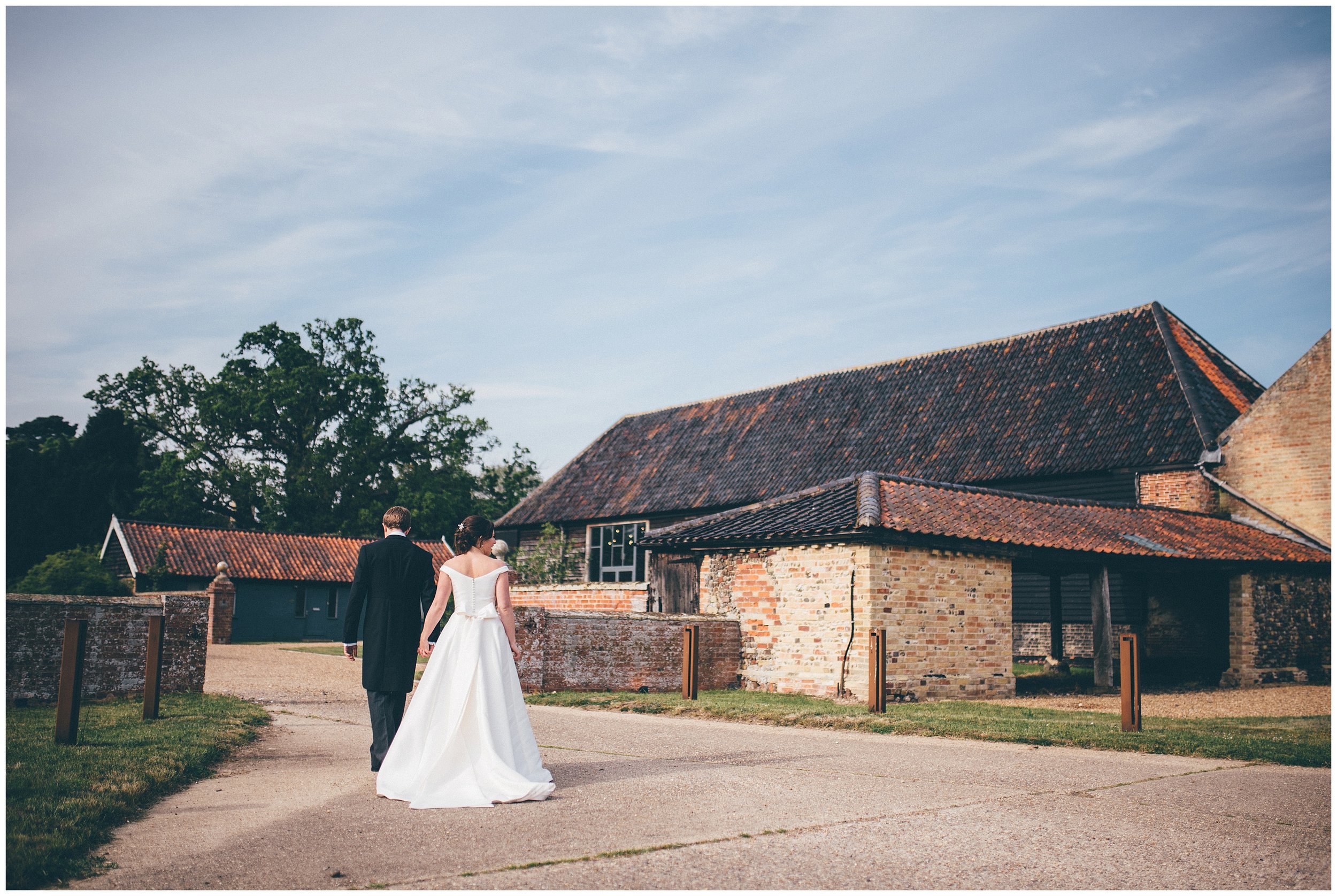 Bride and groom have their wedding photographs taken at Henham Park wedding barns.