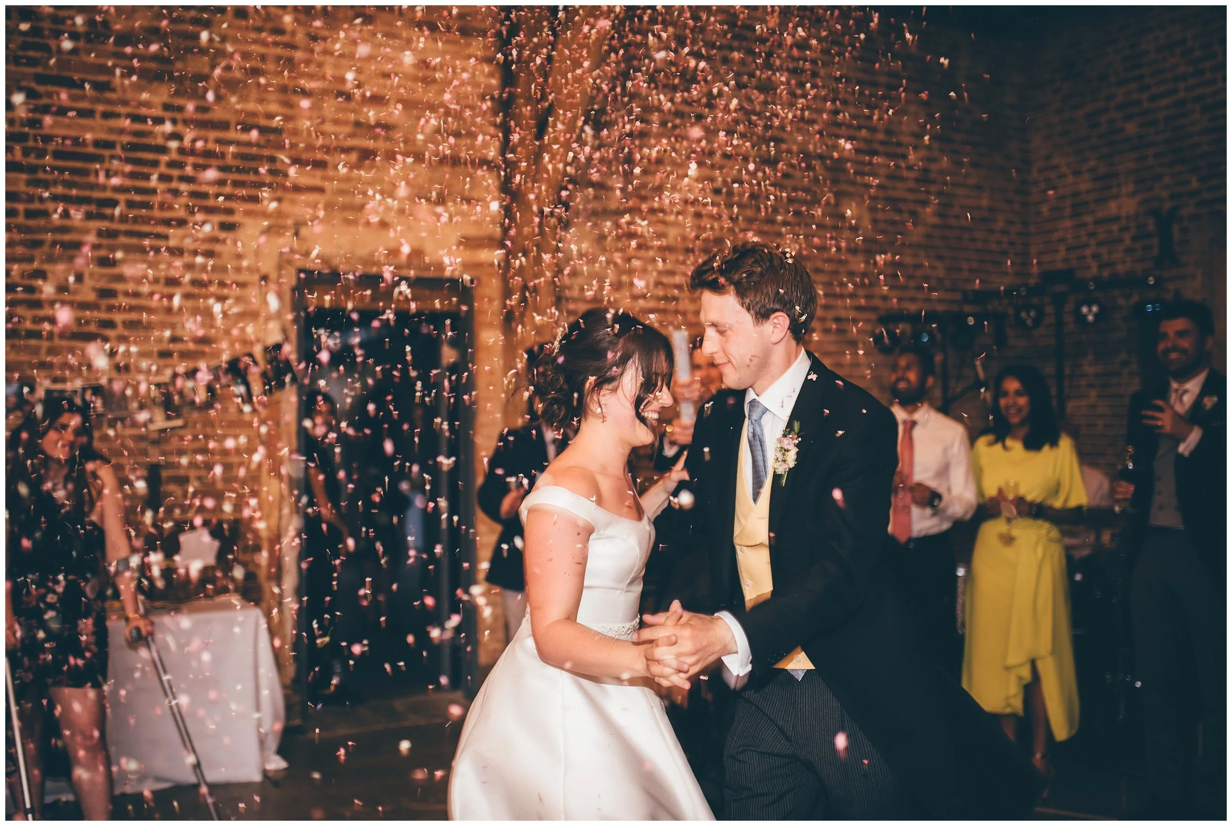 Confetti canon during the First Dance at Henham Park wedding barns in Southwold.