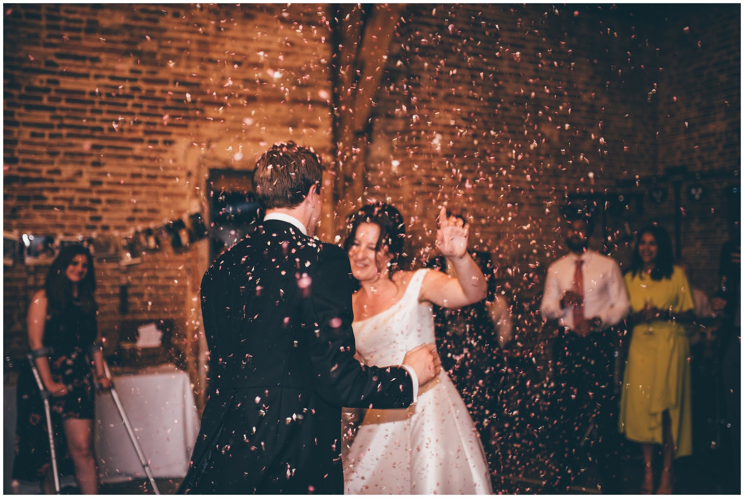 Confetti canon during the First Dance at Henham Park wedding barns in Southwold.