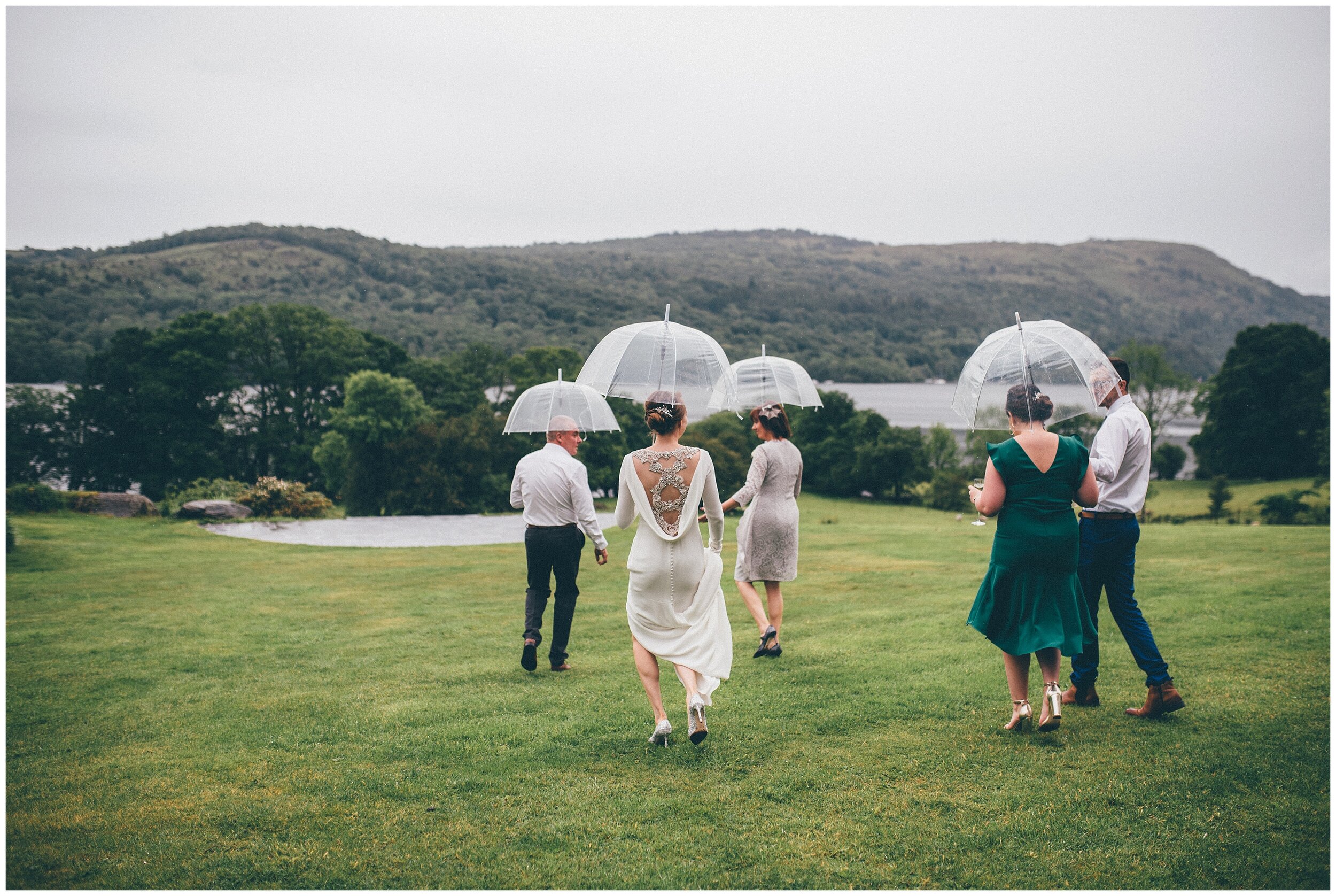 Wedding guests in the rain at Lake District wedding venue.