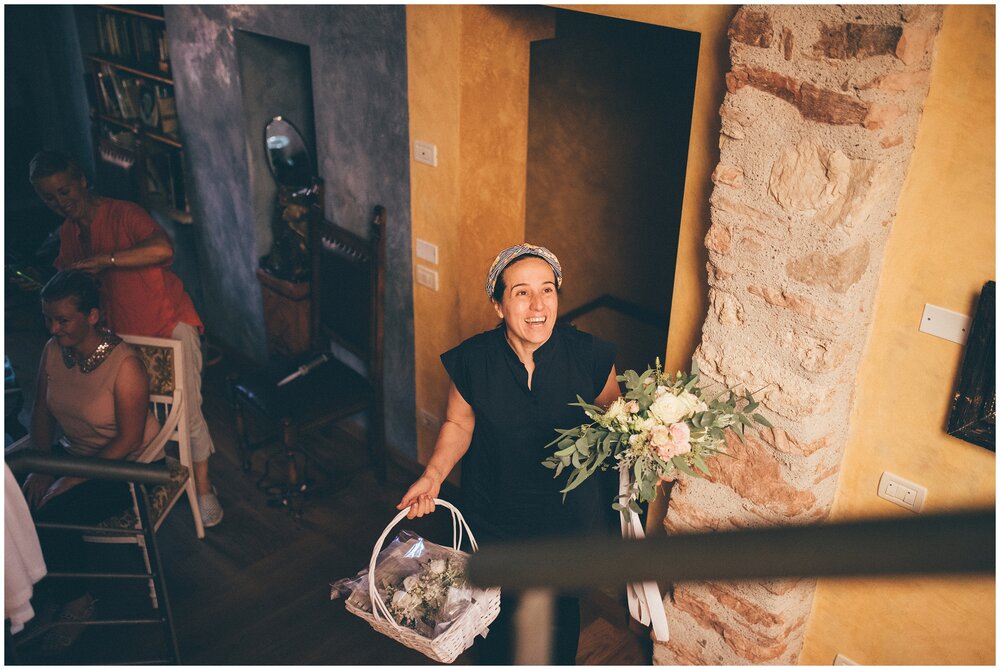 Florist arrives at Essence of Australia dress hung up at the beautiful Agriturismo Villa Bissiniga, Lake Garda.