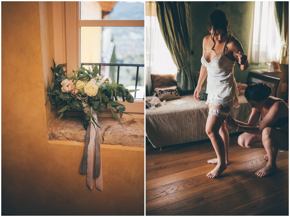 Bridesmaids help bride get ready at Essence of Australia dress hung up at the beautiful Agriturismo Villa Bissiniga, Lake Garda.