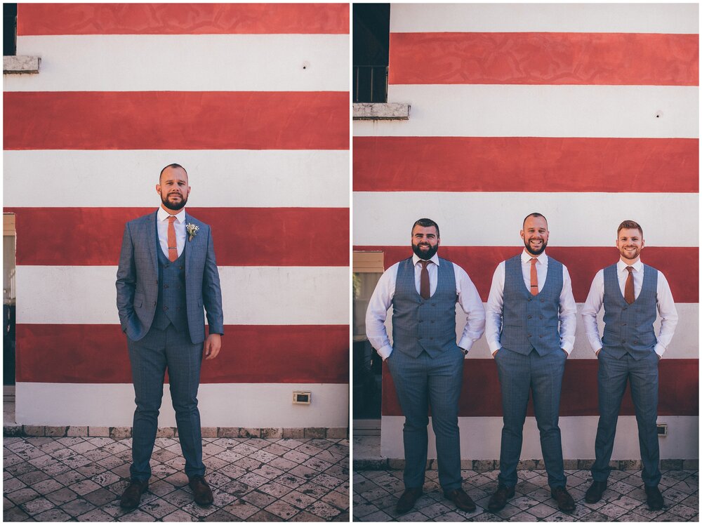 Groom and groomsmen outside at Agriturismo Villa Bissiniga in their Marc Darcy suits.