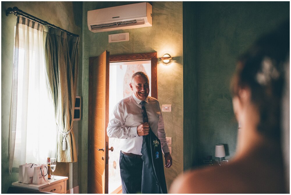 Father of the Bride sees the bride for the first time in her stunning Essence of Australia gown in the bridal suite at Agriturismo Villa Bissiniga.