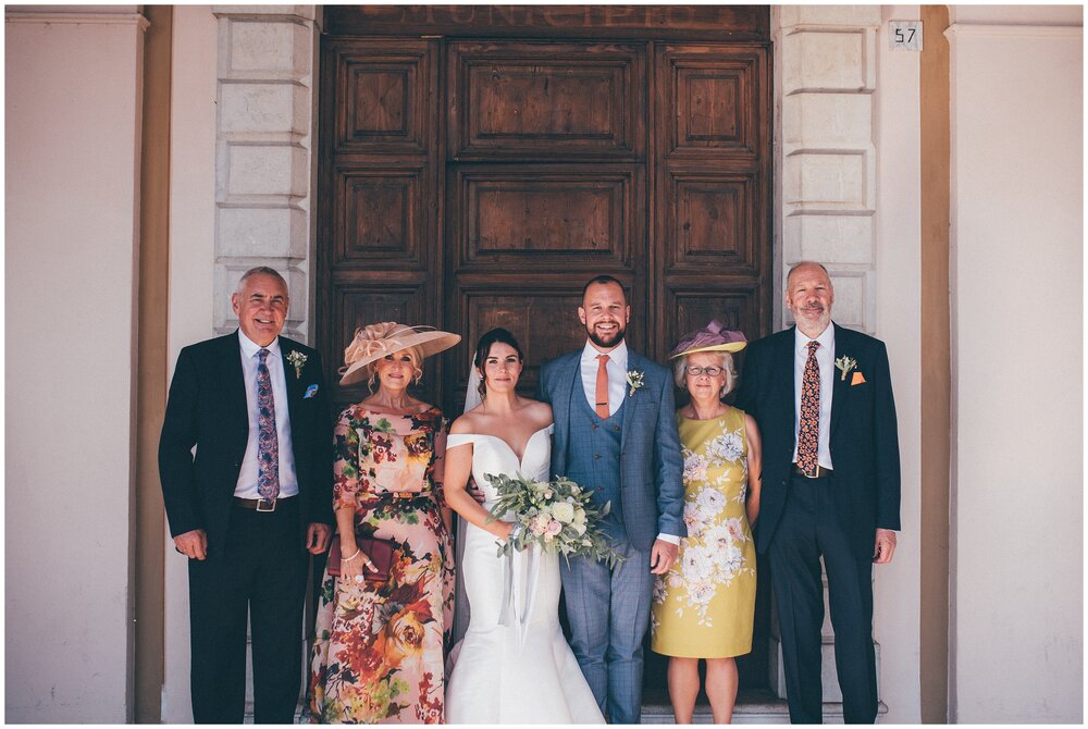 Wedding guests pose for group photograhs at Palazzo della Magnifica Patria di Salo in Salo, Lake Garda.