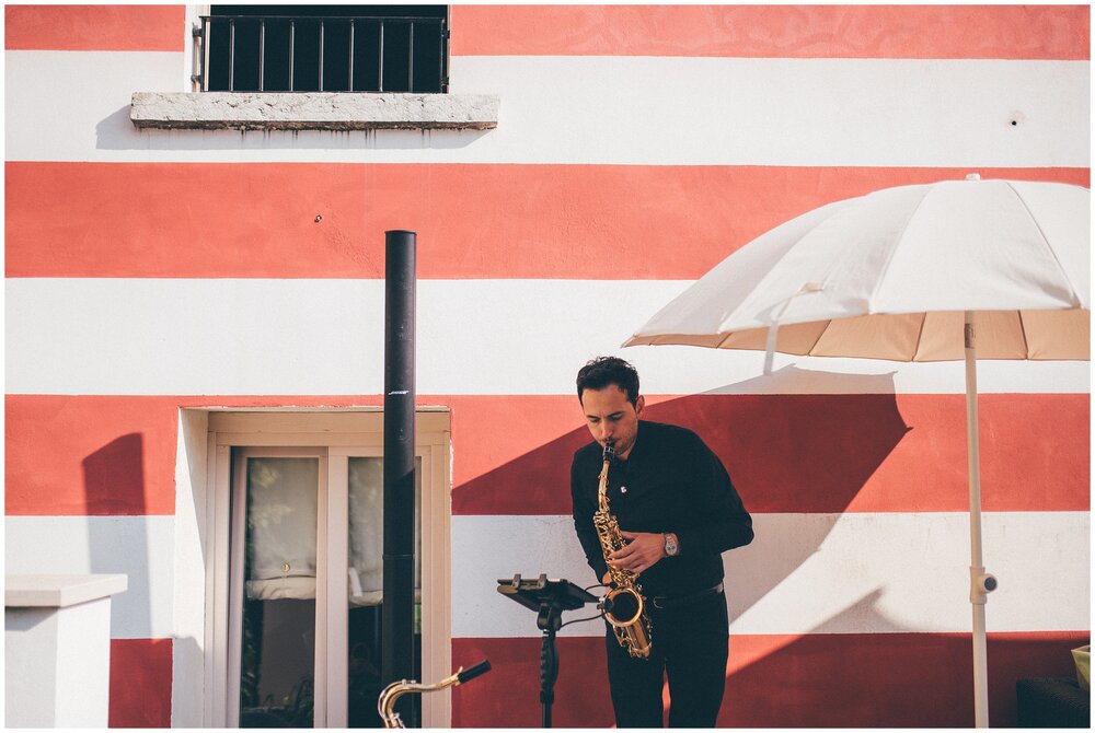 Saxophonist at Agriturismo Villa Bissiniga, Lake Garda wedding venue.