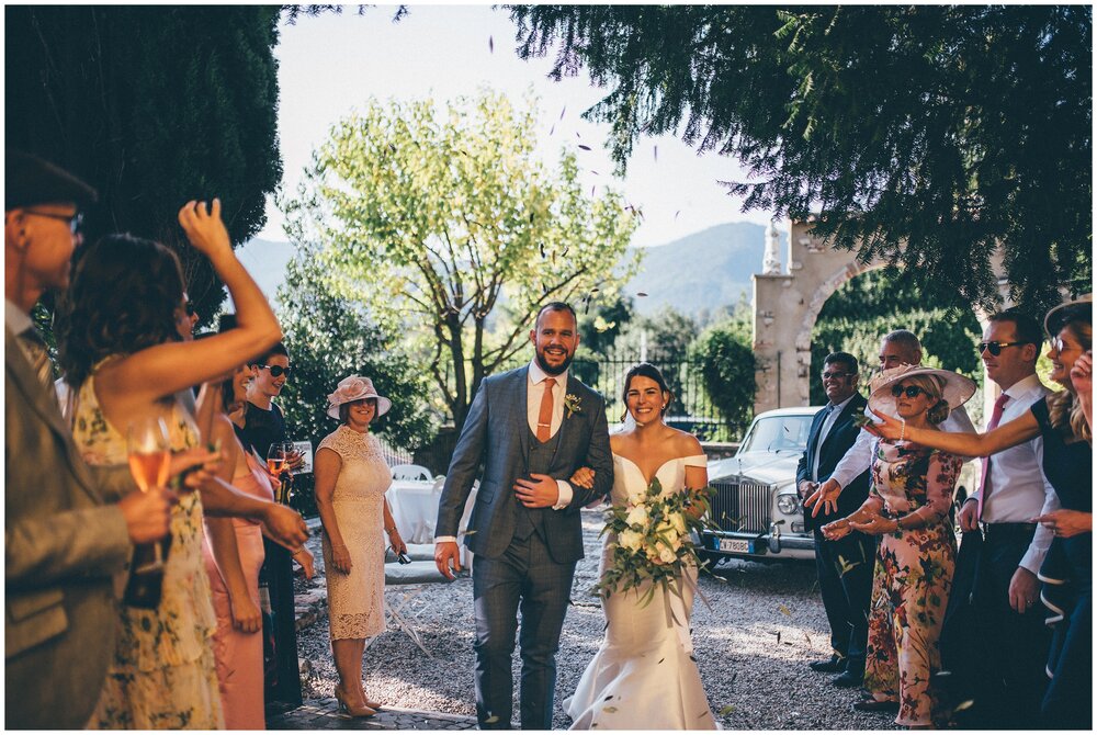 Olive leaf confetti thrown over bride and groom at Agriturismo Villa Bissiniga, Lake Garda wedding venue.
