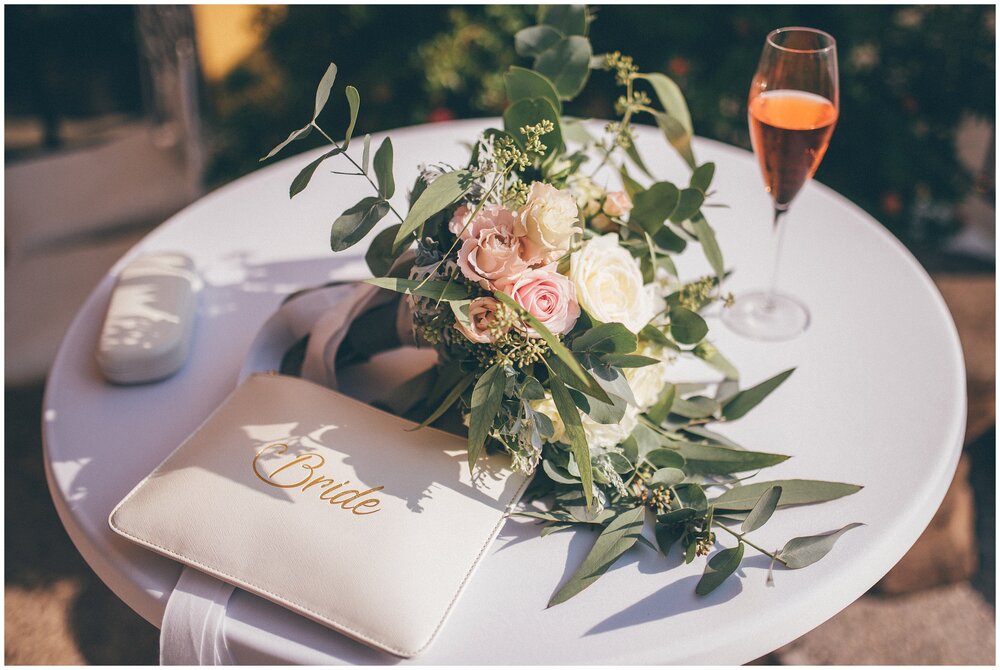 Bride's Katie Loxton bag and wedding bouquet at Agriturismo Villa Bissiniga, Lake Garda wedding venue.