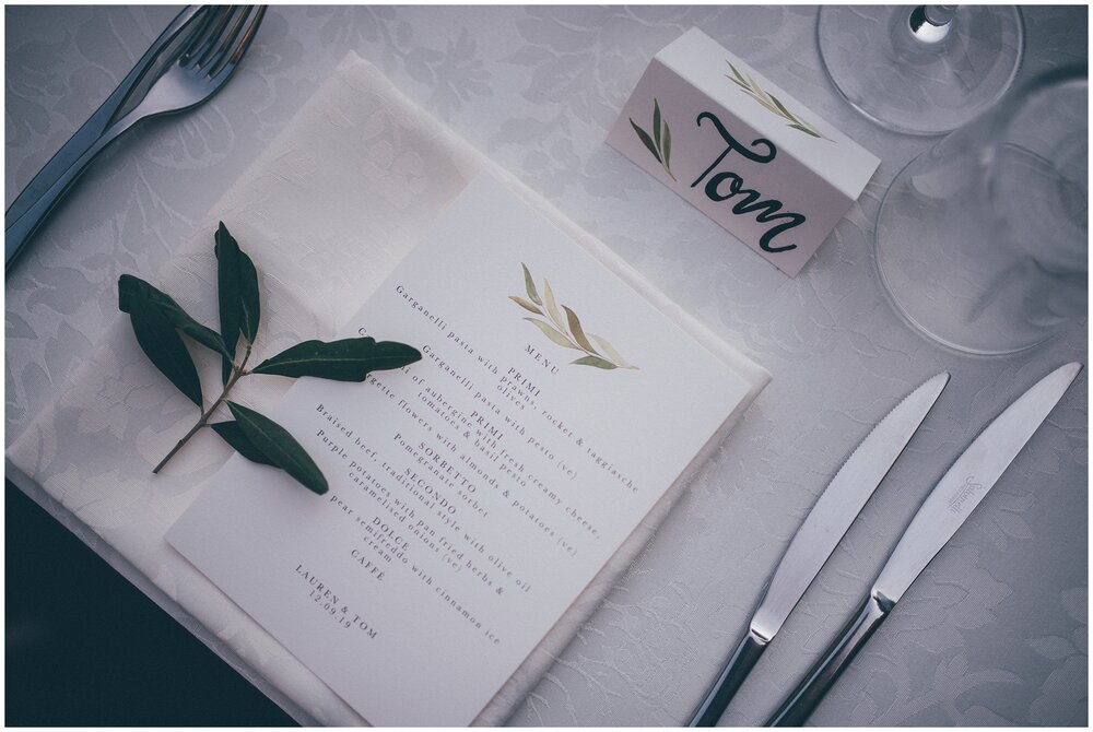 Simple place settings with olive leaves at Lake Garda destination wedding.