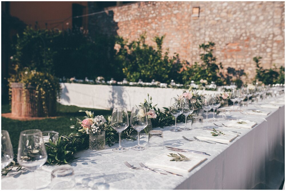 Simple place settings with olive leaves at Lake Garda destination wedding.