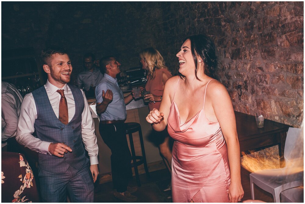 Destination wedding photographer captures wedding guests dancing in Lake Garda.