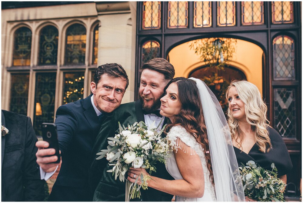 Bride and groom pull funny faces with their friend for a selfie at their winter wedding at Tyn Dwr Hall.