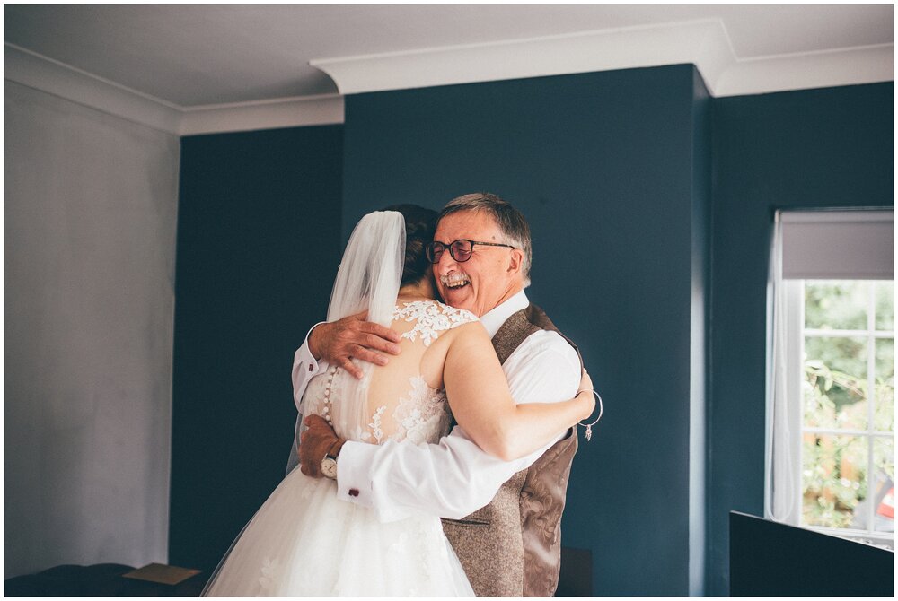 Bride and her dad share a hug before her tipi wedding in Frodsham, Cheshire.