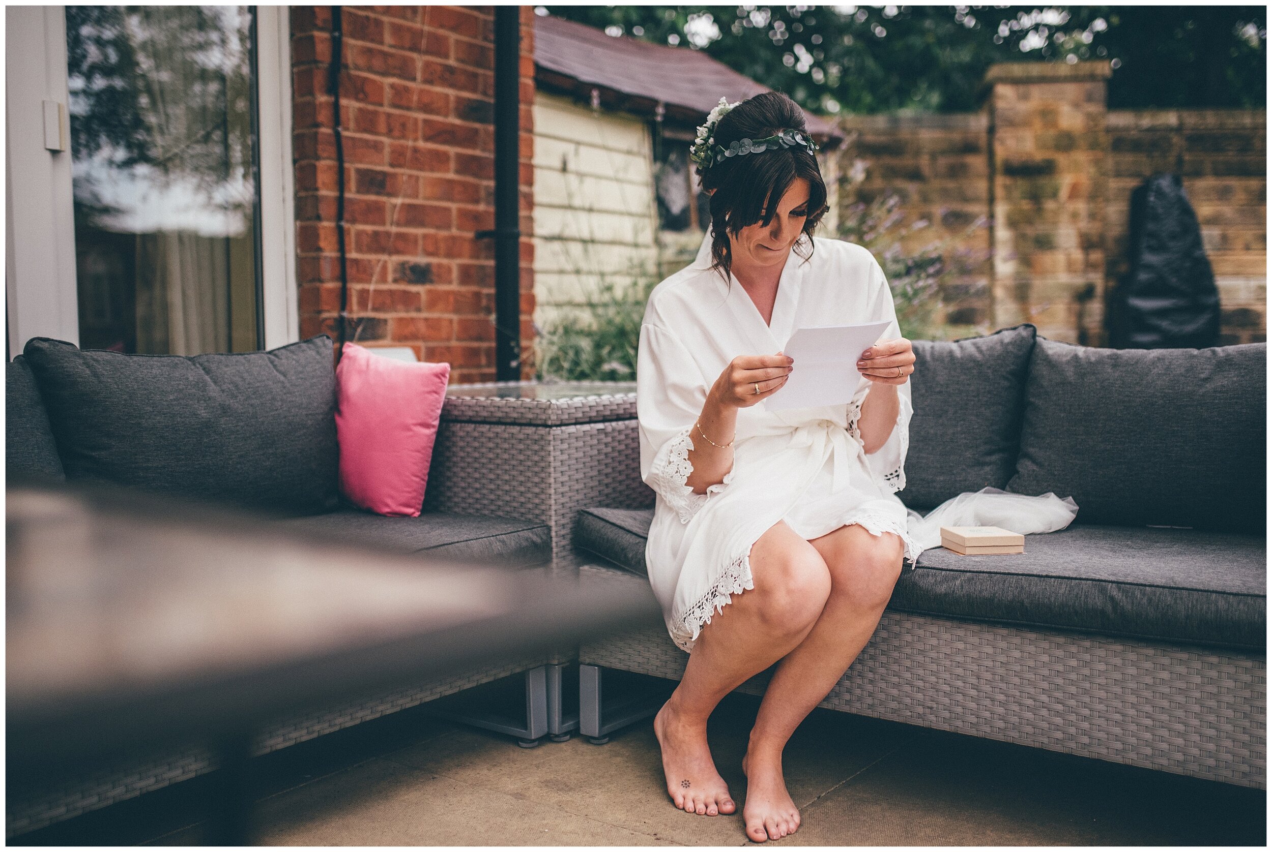 Bride reads her love letter from her husband-to-be before her wedding.