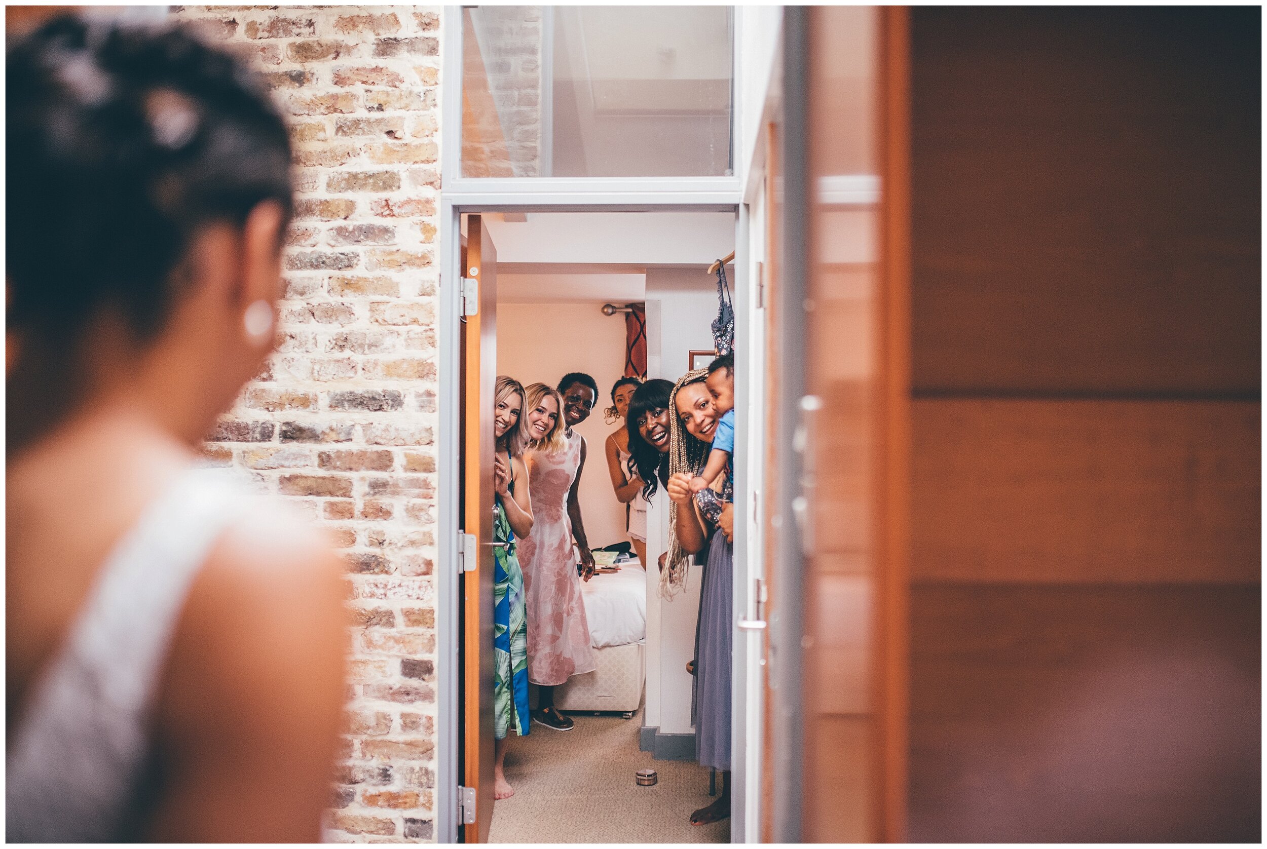 Bridesmaids and family see the bride in her Enzoani gown for the first time in London city centre.