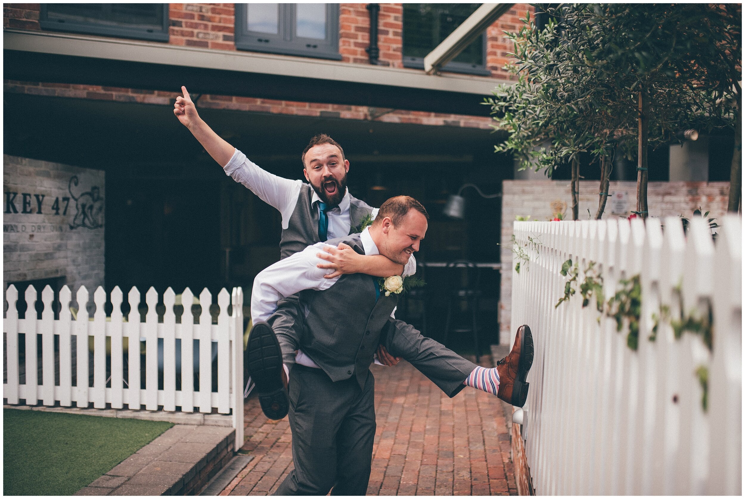 Best Man gives the groom a piggy back at Oddfellows in Chester.