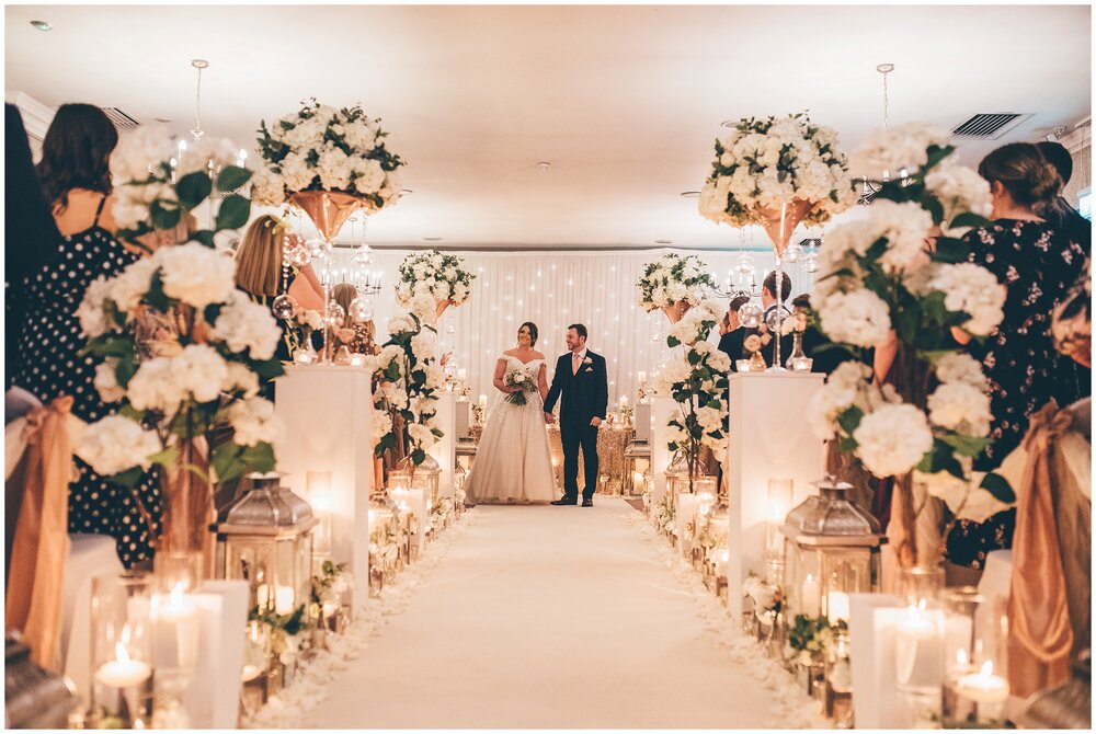 Stunning flower filled and candle filled wedding ceremony at Mottram Hall in Wilsmslow.