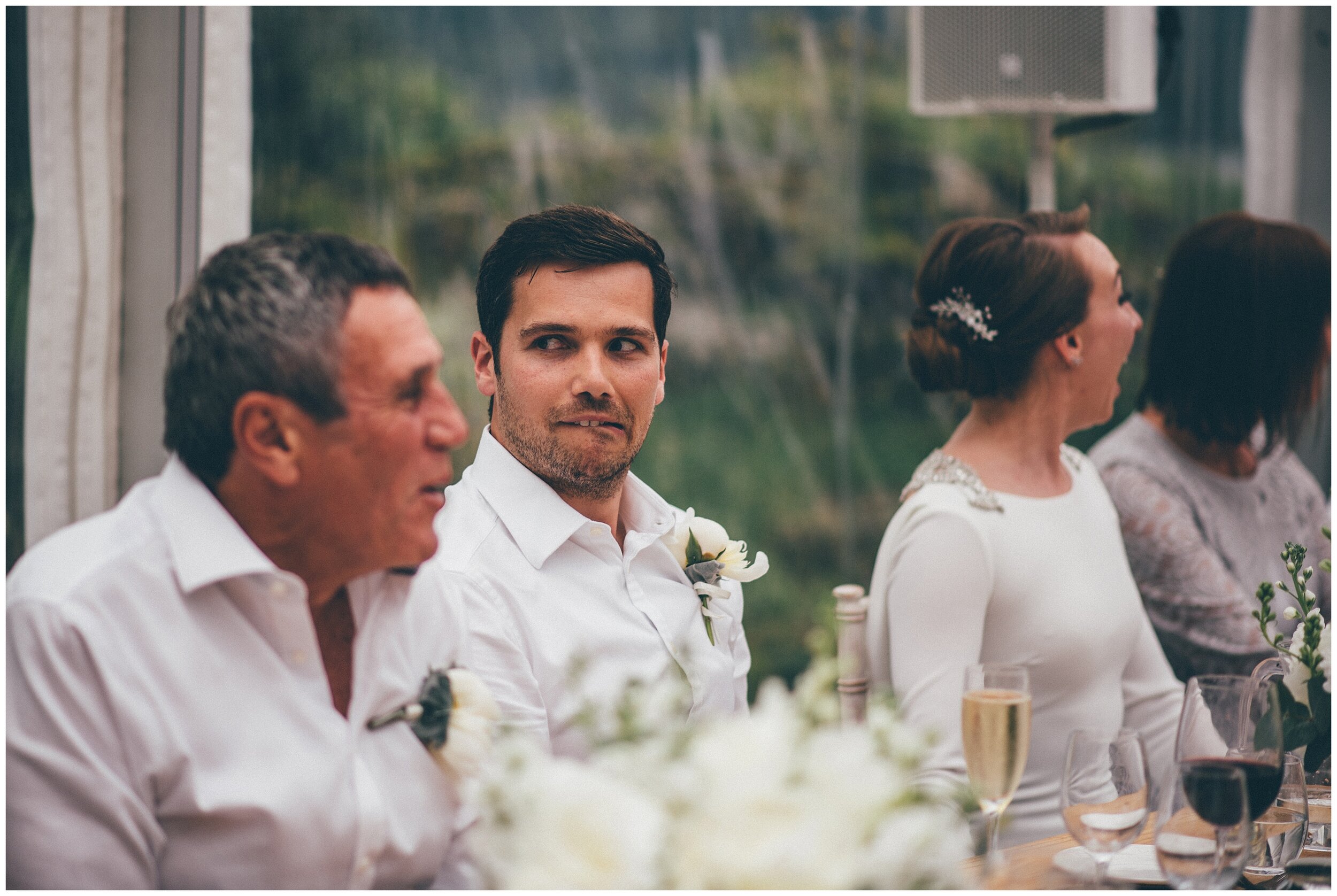 Groom pulls an awkward face during the speeches at Silverholme in the Lake District.