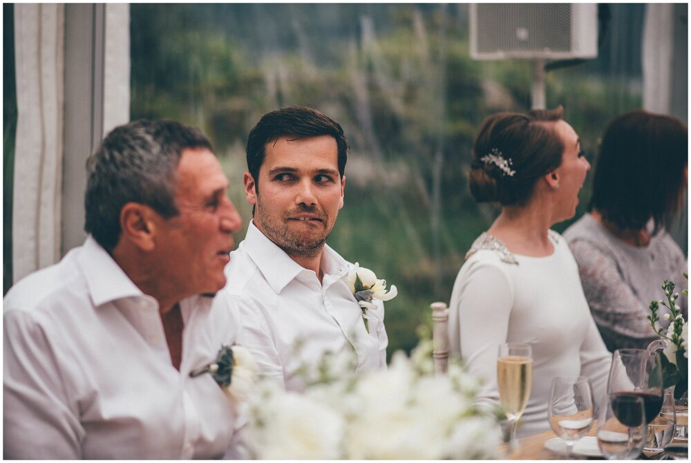 Groom pulls an awkward face during the speeches at Silverholme in the Lake District.