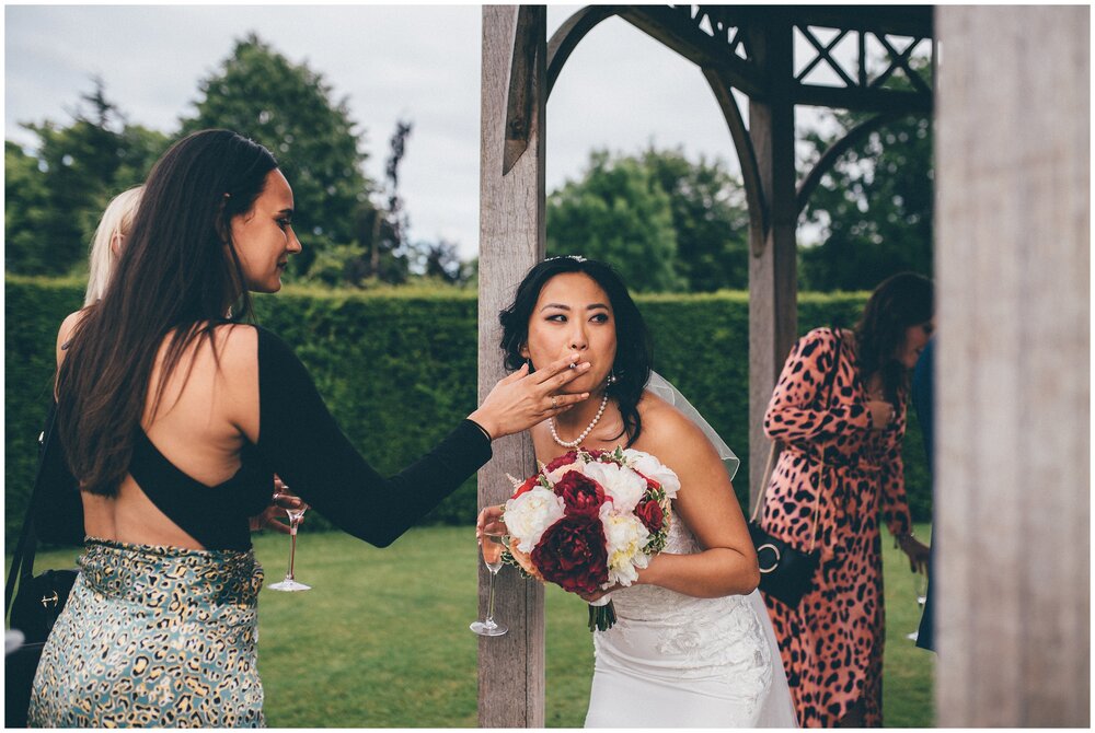 Bride sneaks a cigarette on her wedding day at Chippenham Park Gardens.