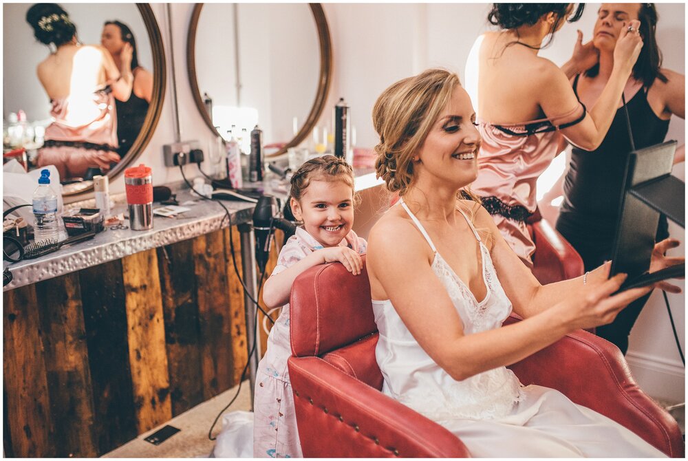 Cute flower girl with her mum on the wedding morning of Cheshire wedding.