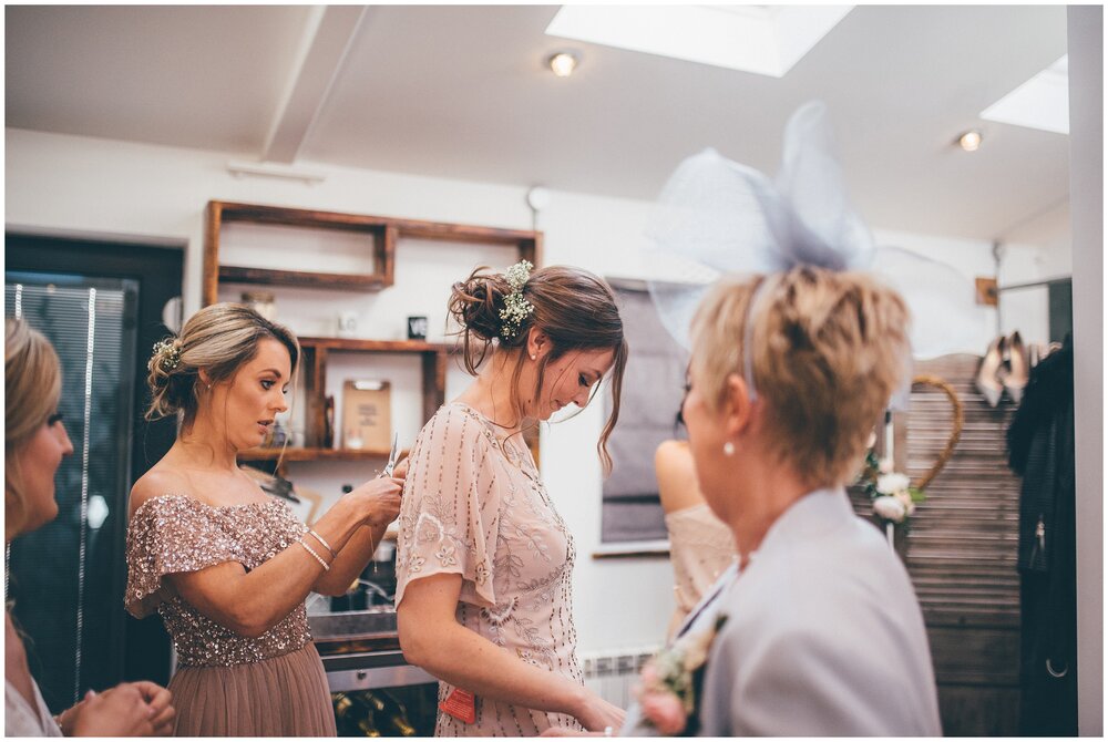 Bridesmaids get ready on the morning of the wedding at Owen house wedding barn in Cheshire.