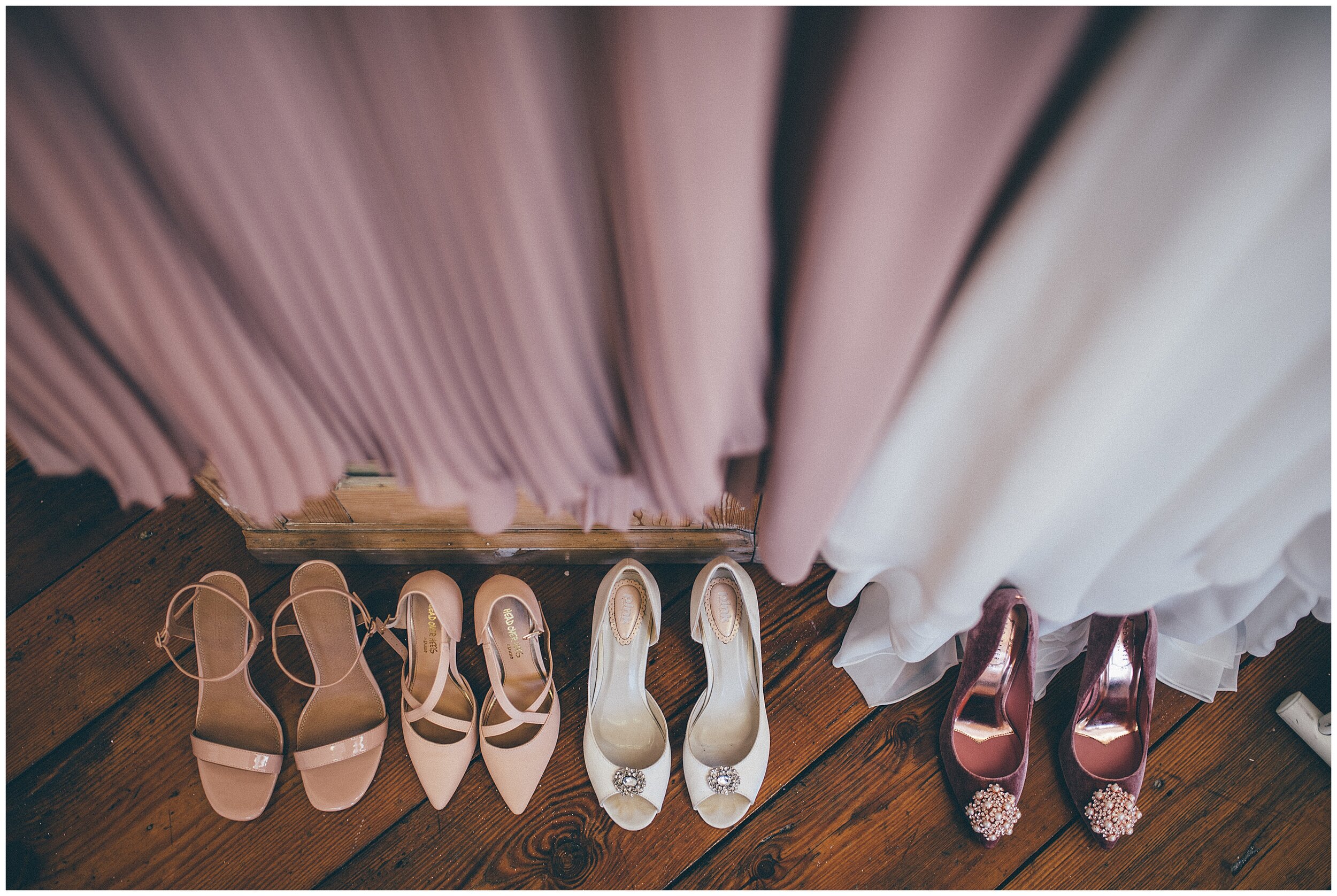Bride and bridesmaids shoes placed neatly together in the bridal suite in Cheshire wedding venue.
