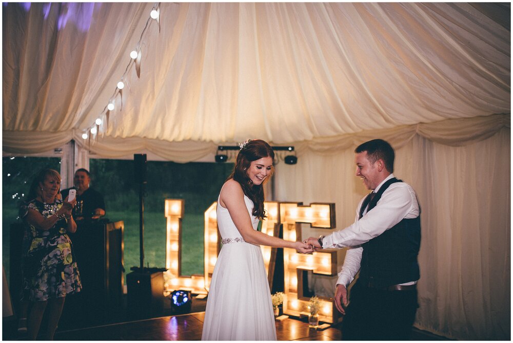 Bride and groom have their First Dance in their marquee Cheshire wedding.