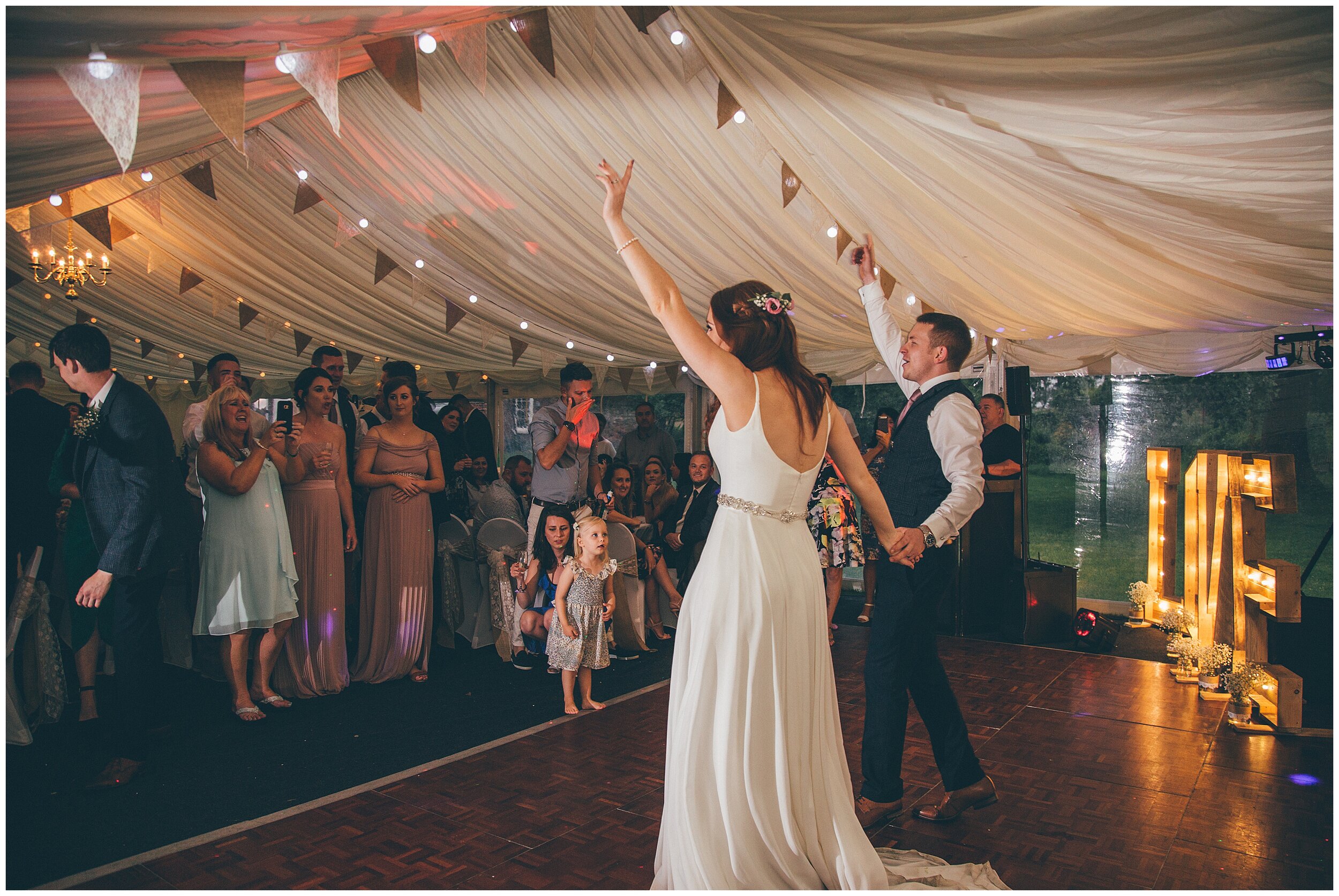 Weddings gusts cheer on bride and groom during their First Dance in marquee wedding in Chester.