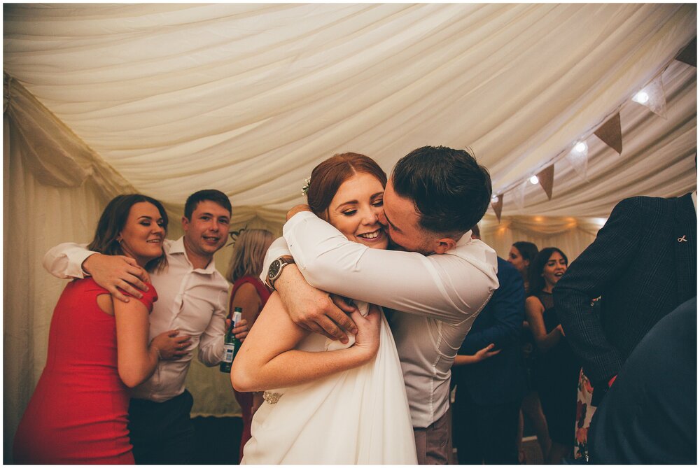 Wedding guests dance during the evening reception at festival-themed wedding in Cheshire.