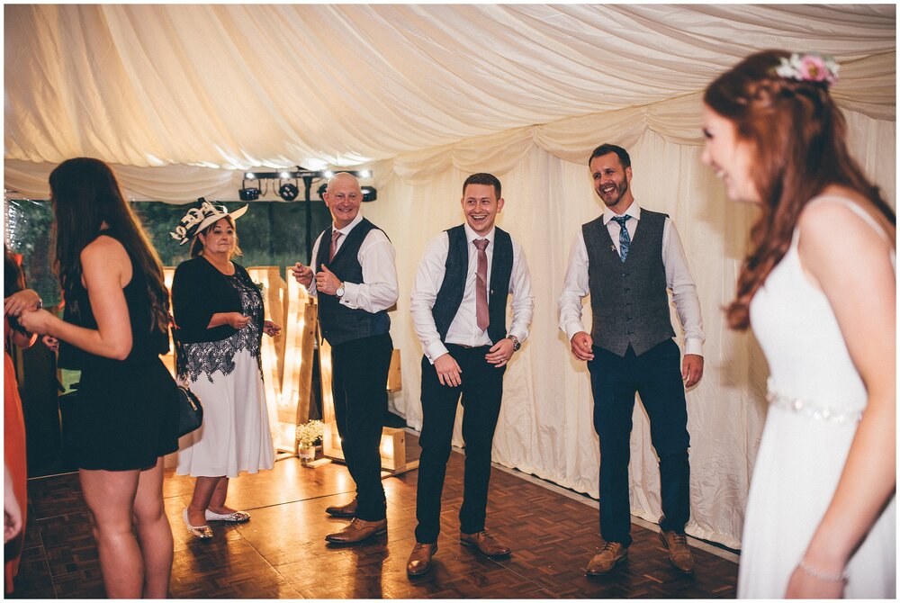 Wedding guests dance during the evening reception at festival-themed wedding in Cheshire.