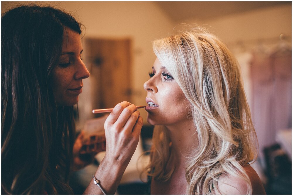 Hereford MUA Katy Phieffer does the finishing touches to beautiful bride's make-up on her wedding morning.