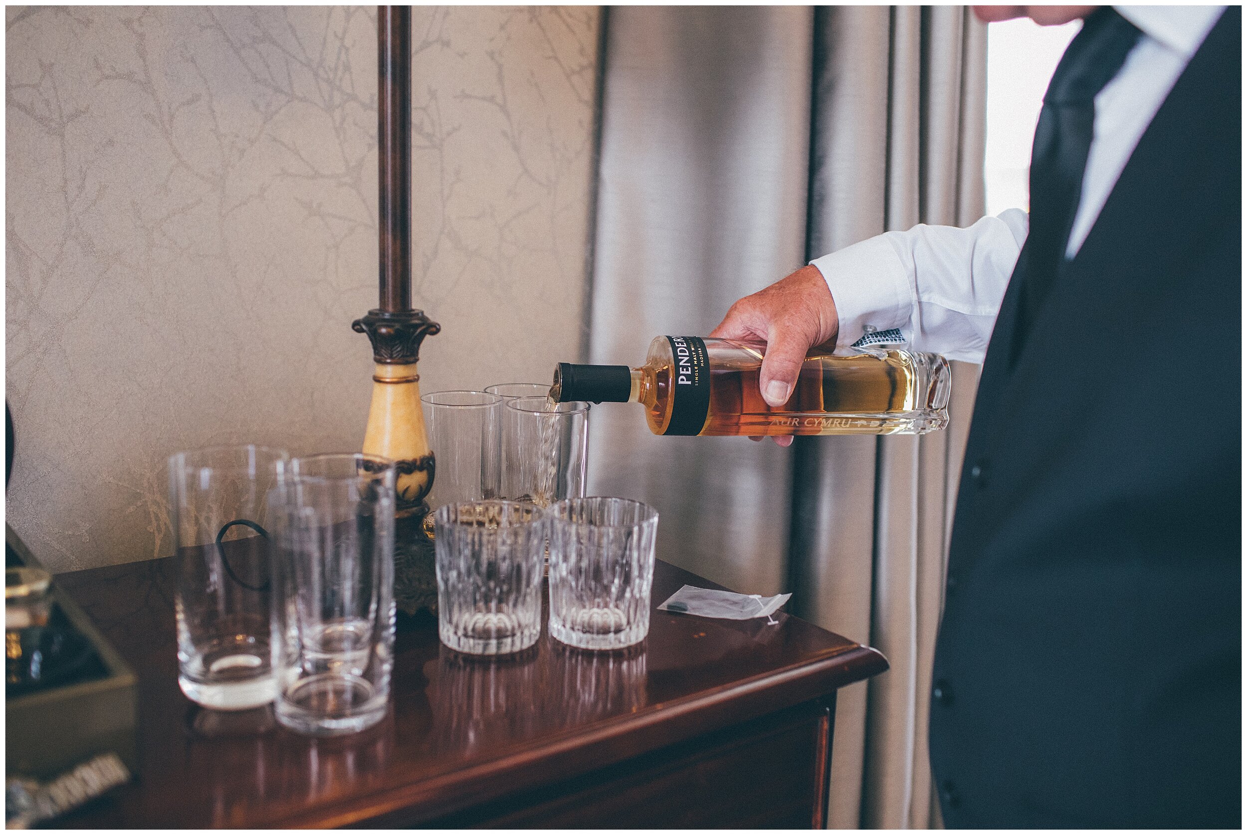 Groomsmen drinking whisky on the wedding morning at Hereford wedding venue, Lemore Manor.