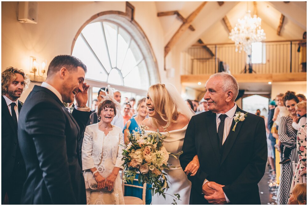 Groom tears up as he sees his beautiful bride arrive at the top of the aisle for the first time at Lemore Manor.