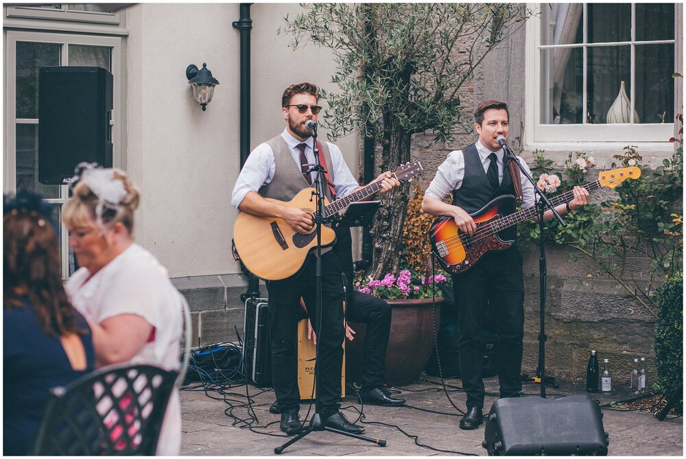 Acoustic wedding duo in the sun at the patio at Lemore Manor wedding.