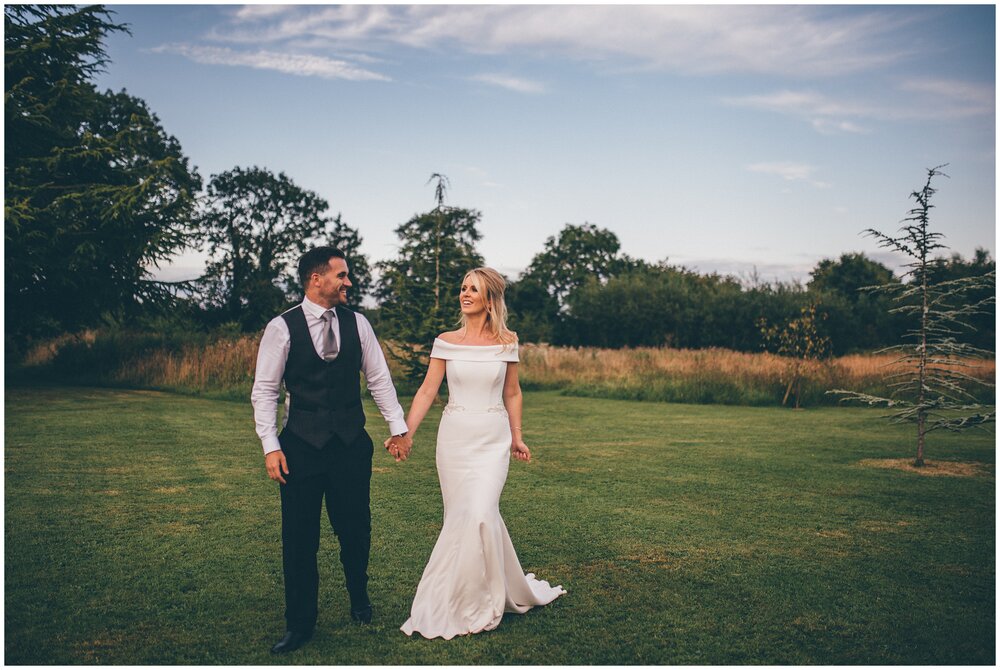 Stunning bride in her Suzanne Neville gown, in the grounds at Lemore Manor in Hereford.