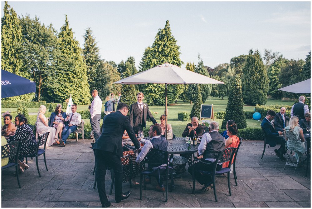 Wedding guests enjoy the summer patio at Lemore Manor in Hereford.