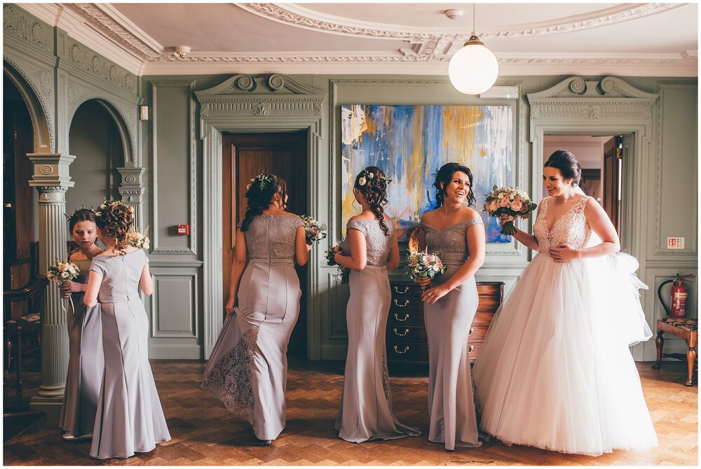 The bride and her bridal party wait for the moment to walk down the aisle.