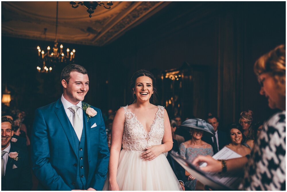 Laughter during the wedding ceremony at Thornton Manor in Cheshire.