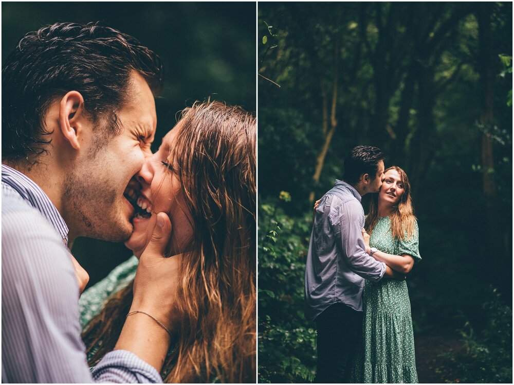 Beautiful and happy young couple kiss in the rainy forest.