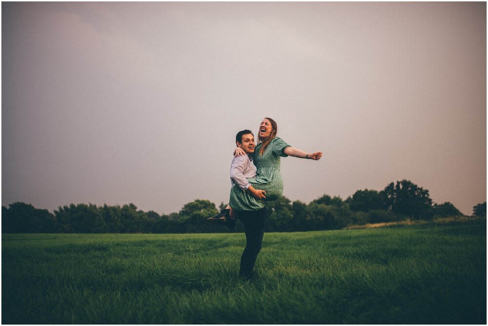 Young woman celebrates hearing thunder and seeing lightening for their couple shoot in Frodsham, Cheshire.