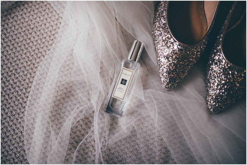 Bride's Jo Malone perfume lay on her veil next to her sparkly shoes.