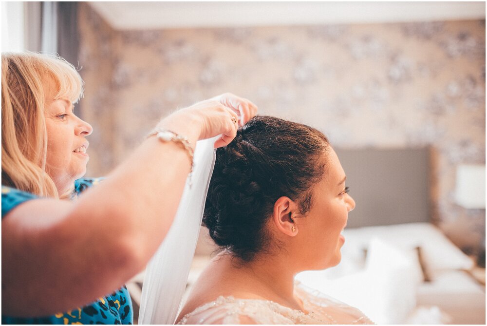 Scottish hairdresser puts the brides veil in before her Scottish elopement in Melrose.